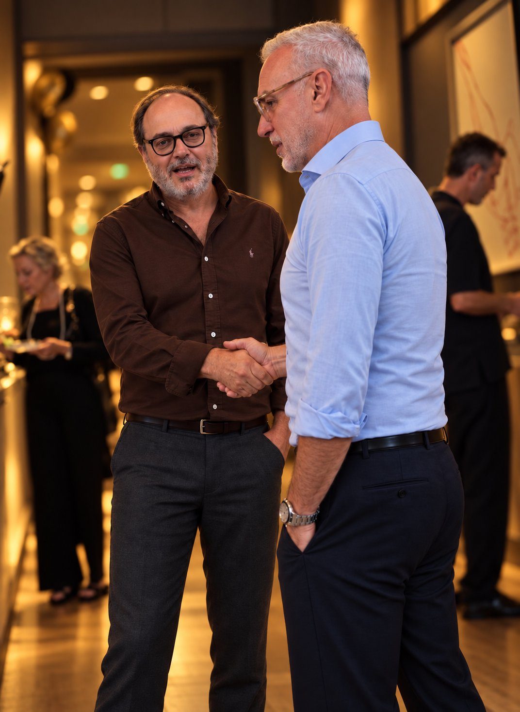 Two guests shaking hands at a private business reception